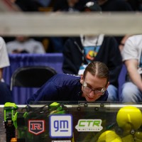 A referee inspects a robot